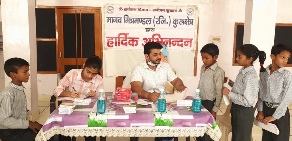 Dr. Deepak Agarwal providing free dental consultations and oral hygiene guidance to students with Manav Mitra Mandal